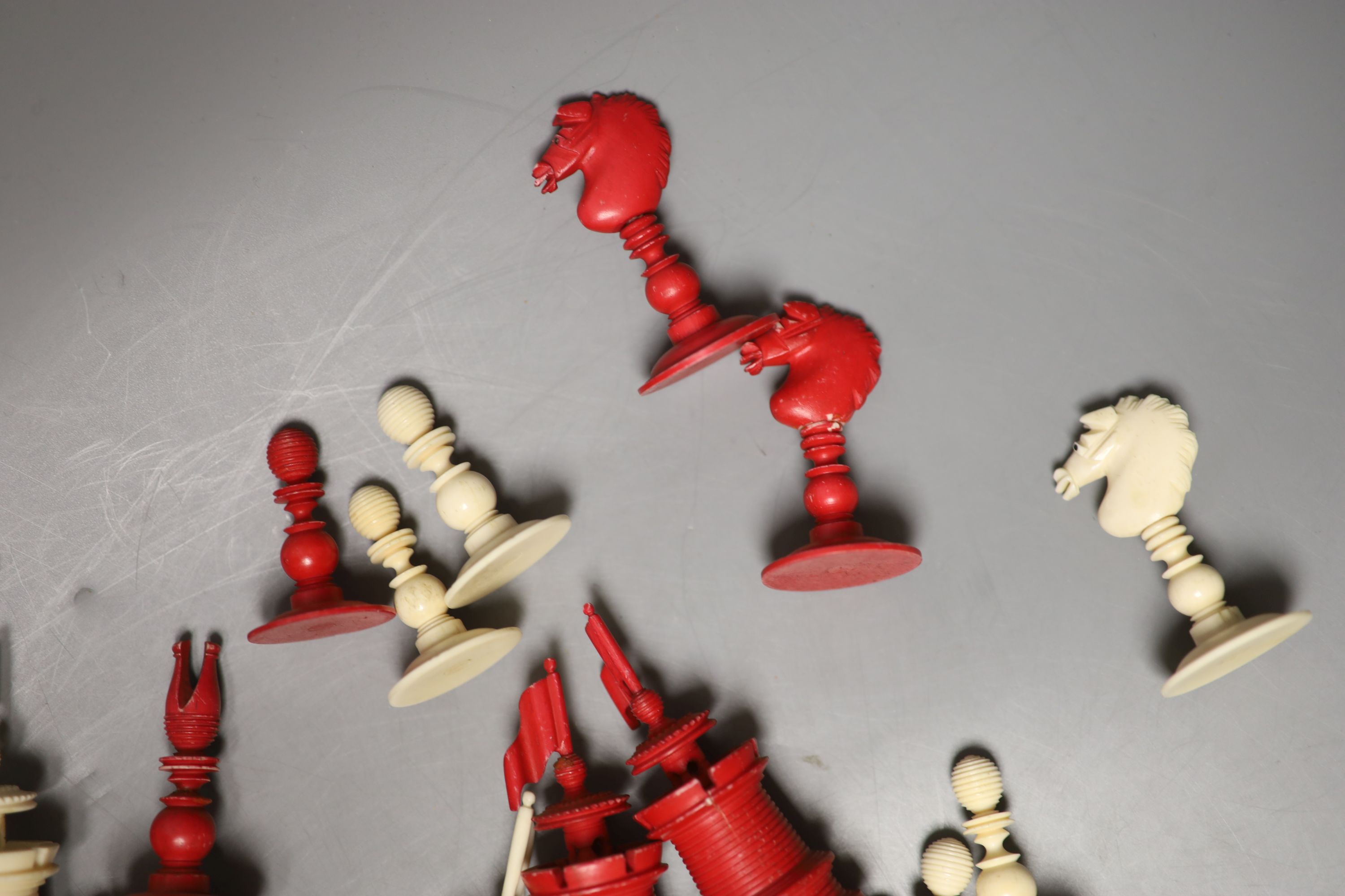 A 19th century natural and red stained bone chess set